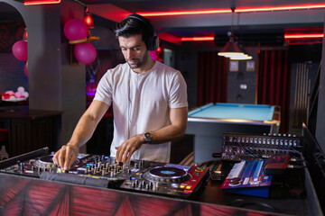 Focused DJ Crafting Mix at Neon-Lit Club