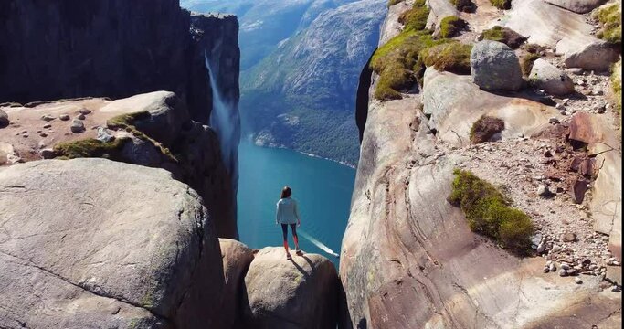 Kjeragbolten, Lysefjord. Norway. Tourist on the stone,  famous boulder in Kjerag above Lysefjord in Norway