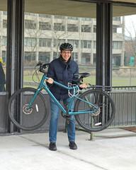 Cheerful student with bicycle at Stony Brook University (SBU), public research university on Long Island in Stony Brook, New York