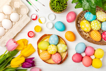 Easter egg painting at the kitchen table.Happy Easter celebration concept.Colorful Easter eggs with...