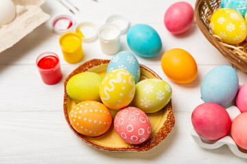Easter egg painting at the kitchen table.Happy Easter celebration concept.Colorful Easter eggs with different patterns.Paints,decorations for coloring eggs for holiday.Creative background.Copy space