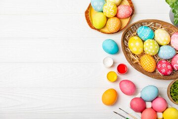 Easter egg painting at the kitchen table.Happy Easter celebration concept.Colorful Easter eggs with...