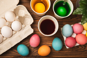 Easter egg painting at the kitchen table.Happy Easter celebration concept.Colorful Easter eggs with different patterns.Paints,decorations for coloring eggs for holiday.Creative background.Copy space