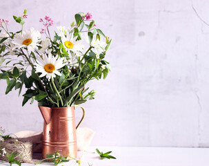 bouquet of wildflowers daisies in a vase on the table