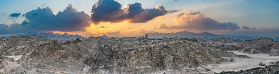 Scenic wide Sunset panorama over Red Sea Hills mountain chain and Sahara desert. Very sharp mountain peaks, wide photo. Hurghada, Egypt