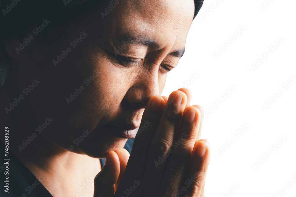 Wall mural Close up woman believes in god, person hands praying on isolated white background. Asian woman stands in meditative pose, holds hands in praying gesture, has sense of inner peace, Religion concept.