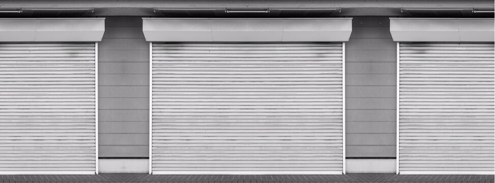 Closed steel shutter door of warehouse, storage or storefront for metal door background and textured.