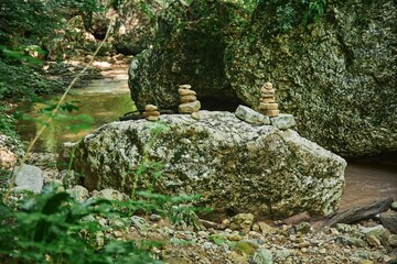 The stones are stacked in the form of a pyramid one on top of the other. Zen-style classes. Relaxation