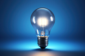 Illuminate your projects with this vibrant photo of a glowing light bulb on a sleek blue background. Perfect for creative or energy concepts.