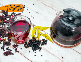 Red berry tea, black elderberry tea. Naturopathy, medical syrup or tincture. Black elderberry medicinal in a drink. Homeopathy