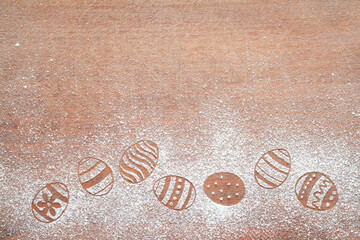 Easter eggs made of flour on chopping board, easter baking background concept, copy space