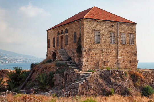 View of the old traditional Lebanese stone house over the Mediterranean sea in Byblos, Lebanon. The house is part of the ancient archaeological complex located next to it.