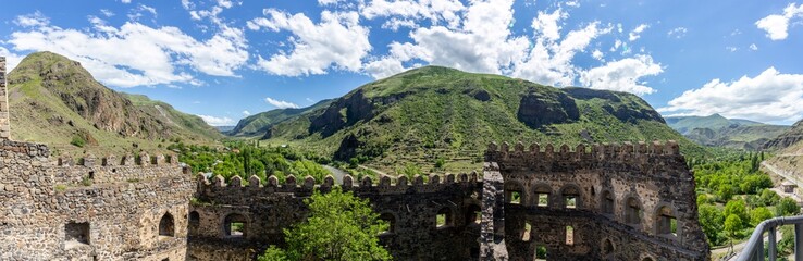 Panorama of Mtkvari (Kura) and Paravani river valley and green Lesser Caucasus mountains with Khertvisi Fortress stone defense crenellated wall, Samtskhe - Javakheti region, Georgia. © Cleop6atra