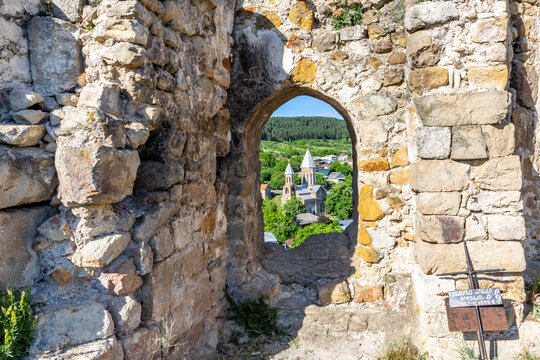 Church of Saint George in Surami, Georgia, seen through stone window frame in medieval Surami fortress.