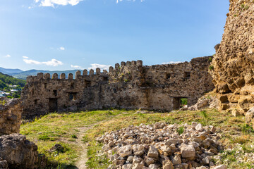 Surami fortress grass courtyard with stone defense crenellated wall with battlements, Georgia.