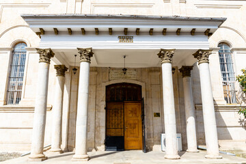 Kutaisi Synagogue entrance, old stone building from 1886 with white columns and wooden carved doors on Boris Gaponov Street, Georgia