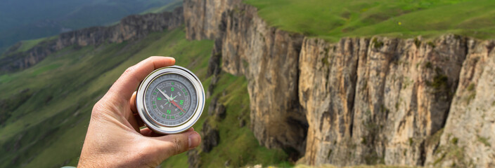 On the ground compass with mountain view
