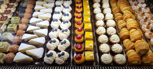Wide selection of delectable pastries and cakes in a bakery showcase