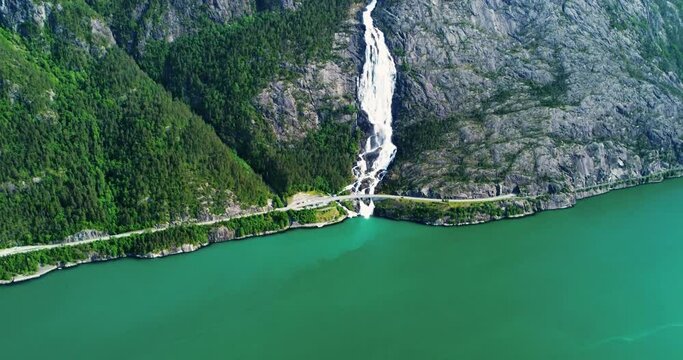 Aerial panning view, waterfall flowing down mountain side. Tourism in Iceland. Inspiration in nature. Langfoss waterfall. Langfossen