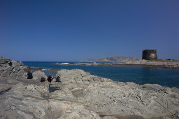 photographer and Shale cliffs at Capo Falcone. Tower la Pelosa Stintino (SS), Sardinia. Italy