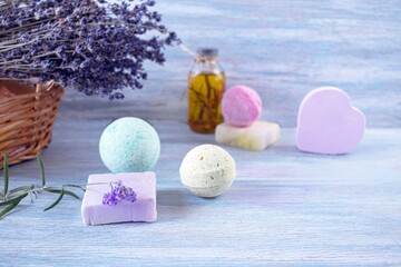 Lavender soap, fragrance oil, foam bombs and fresh lavender flowers on a wooden background, bath products