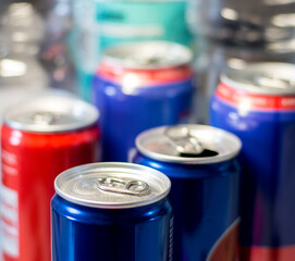 red and blue aluminium cans
