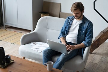 Businessman working with laptop from home.