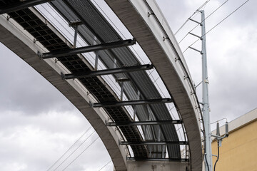 Fototapeta premium Under a tramway rail in a grey sky