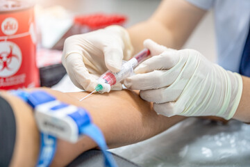 Close up hand of nurse, taking blood sample from a patient in the hospital.
