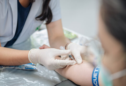 Close up hand of nurse, taking blood sample from a patient in the hospital.