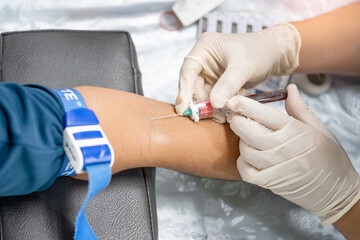 Close up hand of nurse, taking blood sample from a patient in the hospital.
