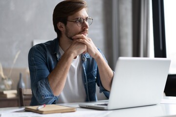 Fototapeta premium Businessman working with laptop from home sitting at table.