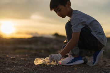 Kids volunteer help garbage collection charity environment. Improving environment. Energetic male volunteer using garbage bag while collecting litter
