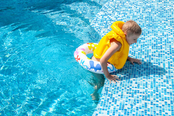 Little boy in the pool during vacation - 745237162