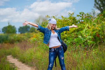Happy girl in a bandana on a background of nature - 745237528
