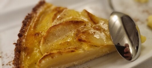 Close-up of a delicious slice of apple pie with cinnamon, ready to be enjoyed