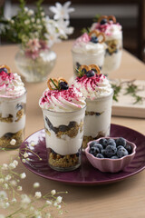Dessert with blueberries and whipped cream in flower cut cups