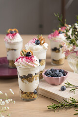 Dessert with blueberries and whipped cream in flower cut cups