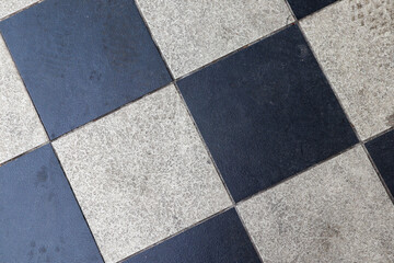 floor with chess-shaped black and white tiles
