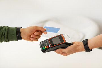Cropped of man using credit card while making contactless payment