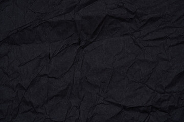 Black paper with textured, torn edges on a contrasting background.