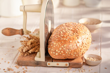 Loaf of oat bread baked in a rustic bright kitchen.