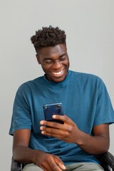 Joyful disability young man enjoying social media on his smartphone. Happy and connected: modern communication lifestyle. Casual lifestyle portrait of a smiling man with a mobile phone.