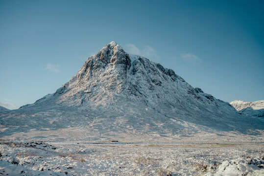 The Buachaille mountain, covered in snow, rising up from Rannoch Moor in Glencoe, Scotland