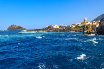 Fototapeta premium The volcanic rock coastline and blue turquoise water at the historic town of Garachico, Spain, on the Northern coast of Tenerife, an island in the Atlantic Ocean and part of the Canary Islands.