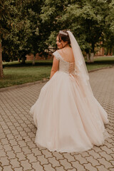 Obraz premium Caucasian young woman bride spinning whirls dancing posing moving at nature