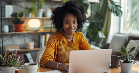Black woman, typing in home office and laptop for research in remote work, social media or blog in apartment. Freelance girl at desk with computer writing email, website post and online chat in house 
