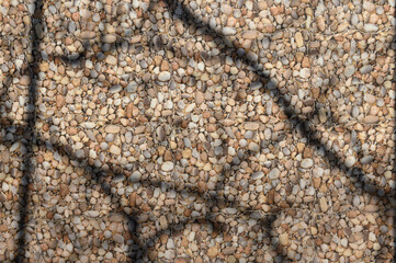 sea ​​stones and shadows from branches on the wall as a background 1