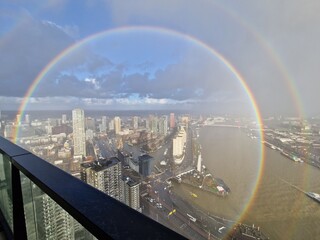 Double circular rainbow or Glory over the skyline of Rotterdam
