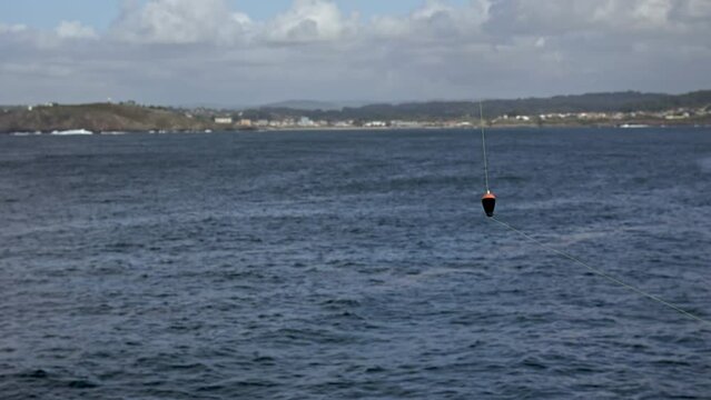 Fishing Float on the Open Sea: A Calm Day for Anglers